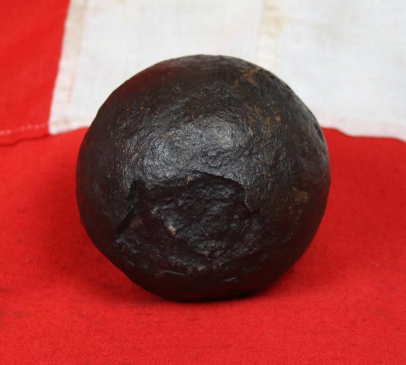 A Superb Original Waterloo Recovered Souvenir '6 Pounder ' Royal Artillery Cannon Ball Fired at La Haye Sainte During The Battle, Recovered From The Farm. With Clear impact Site To The Ball.