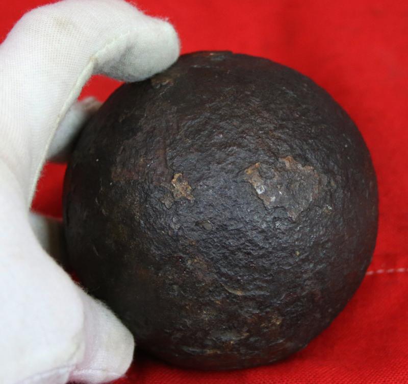 A Superb Original Waterloo Recovered Souvenir '6 Pounder ' Royal Artillery Cannon Ball Fired at La Haye Sainte During The Battle, Recovered From The Farm. With Clear Impact Site To The Ball.