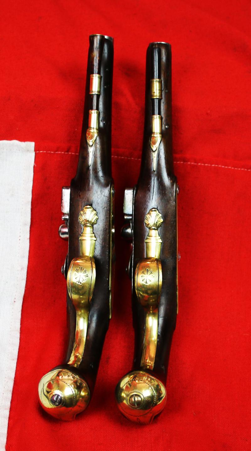 A Very Fine Pair of 1770's Gentleman' or Officers Holster Pistols. Fine Juglans Regia Walnut Stocks, All Brass Cast Furniture Mounts Beautifully Engraved. Bright Steel Barrels & Flintlocks Signed Waters & Ward
