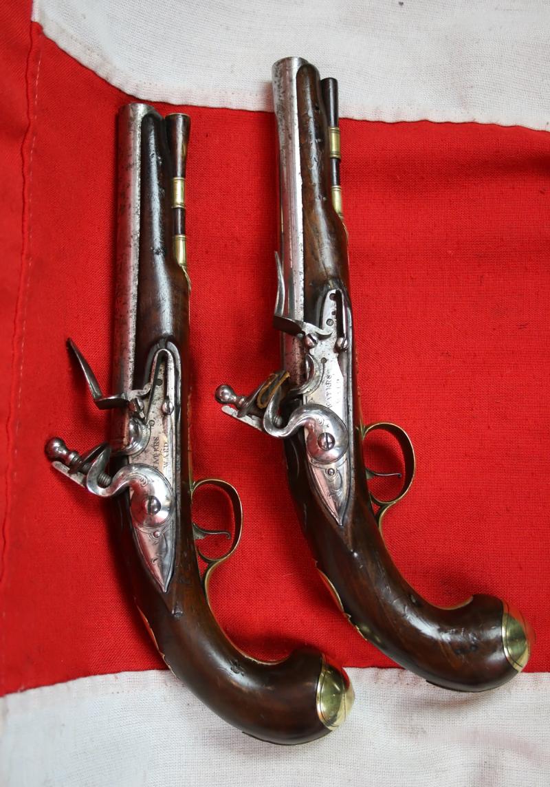 A Very Fine Pair of 1770's Gentleman' or Officers Holster Pistols. Fine Juglans Regia Walnut Stocks, All Brass Cast Furniture Mounts Beautifully Engraved. Bright Steel Barrels & Flintlocks Signed Waters & Ward