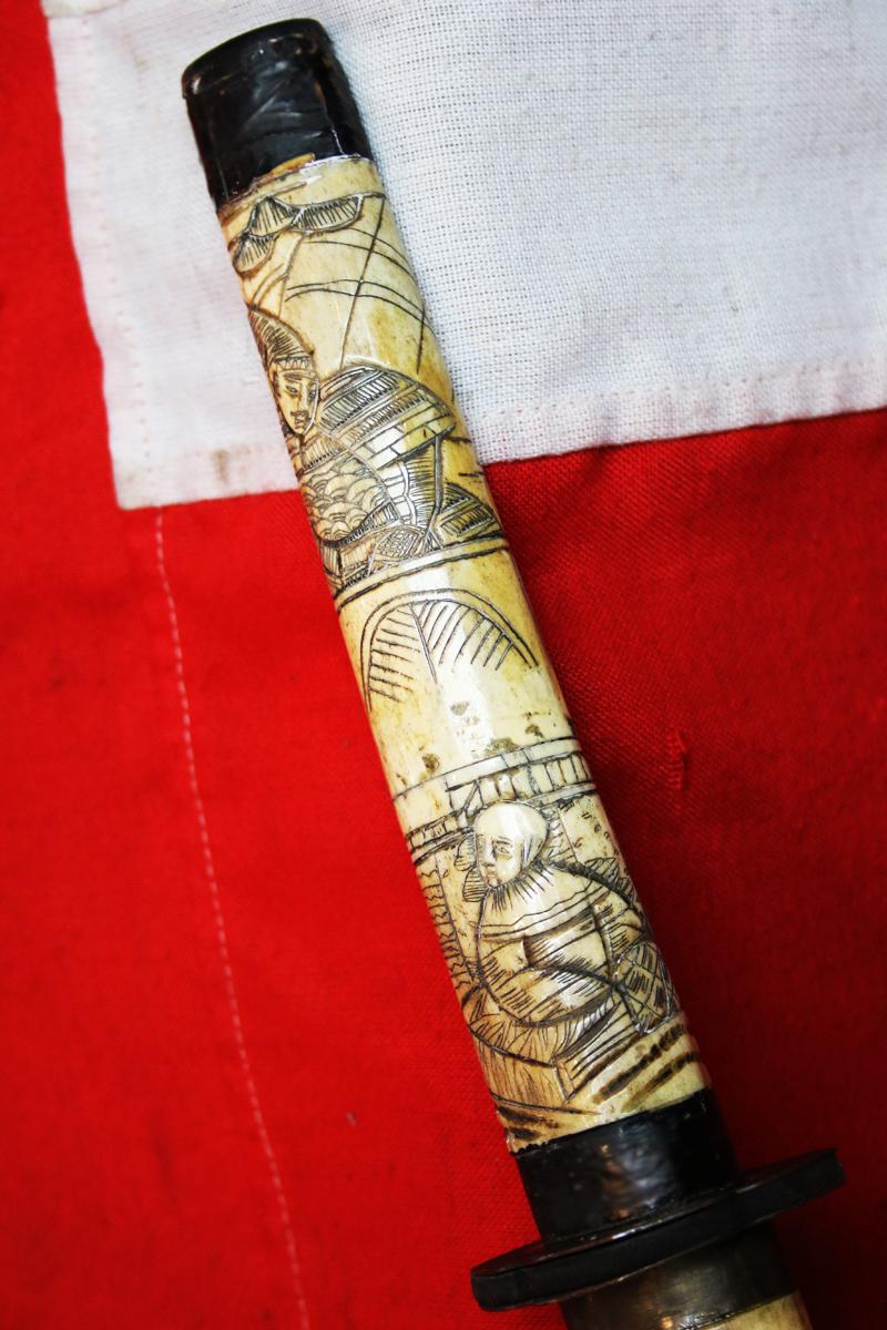 A Late 19th Century Most Attractive Hand Carved Japanese Samurai Style Export Sword From the Late Edo to Taisho Period. Decorated Throughout With Takebori Carved Figures of Armoured Samurai & Nobles In Court Dress